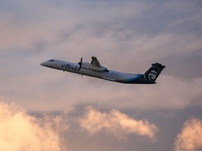 In this file photo taken on August 11, 2018 an Alaska Airlines Bombardier Dash 8 Q400 operated by Horizon Air takes off from at Seattle-Tacoma International Airport.