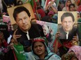 Supporters of Pakistan's former prime minister Imran Khan, carry placards displaying a portrait of Khan during a protest in Karachi on March 19, 2023, demanding release of arrested party workers in recent police clashes.