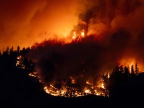 The McDougall Creek wildfire burns in the hills of West Kelowna on Aug. 17, 2023.