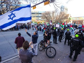 Palestinian supporters rally in downtown Calgary to protest the ongoing conflict between Israel and Hamas on Sunday, October 15, 2023. A small number of Israel supporters also rallied nearby.