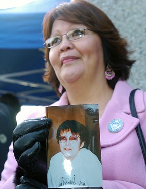Sandra Gagnon holds a photograph of her sister, murder victim Janet Henry, outside the Law Courts as Canada's largest mass murder trial begins on Jan. 20, 2006.