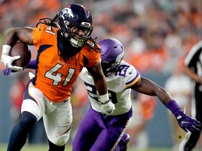 Former Denver Broncos running back JaQuan Hardy (41) runs the ball as Minnesota Vikings cornerback Kris Boyd (29) pursues during the first half of an NFL preseason football game, Saturday, Aug. 27, 2022, in Denver. Hardy is now a B.C. Lion.