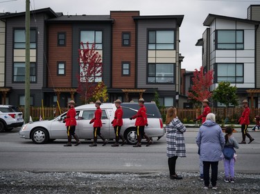 RCMP officers march beside a hearse carrying RCMP Const. Rick O'Brien's casket to a regimental funeral in Langley, B.C., on Wednesday, October 4, 2023. O'Brien, 51, was killed last month while executing a search warrant at a home in Coquitlam.