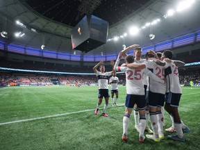 Vancouver Whitecaps' Brian White (24) celebrates with his teammates after scoring against St. Louis City during the second half of an MLS soccer match in Vancouver, on Wednesday, October 4, 2023.
