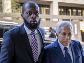 Prakazrel "Pras" Michel, left, a member of the 1990s hip-hop group the Fugees, accompanied by now-former defence lawyer David Kenner in March. A motion for new trial has been filed by Michels's new lawyers.