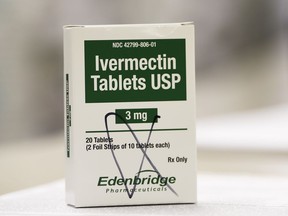 FILE: A box of ivermectin is shown in a pharmacy as pharmacists work in the background, Thursday, Sept. 9, 2021, in Ga.