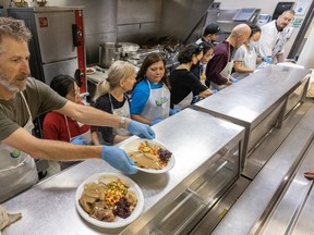 Chef Greg Ashby hands over Thanksgiving meals served at Union Gospel Mission in Vancouver, B.C., October 9, 2023.