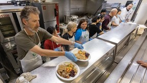 Chef Greg Ashby hands over Thanksgiving meals served at Union Gospel Mission in Vancouver, B.C., October 9, 2023.