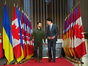 Ukrainian President Volodymyr Zelenskyy and Prime Minister Justin Trudeau arrive for a joint media availability in Ottawa on Friday, Sept. 22, 2023. A new survey by Leger suggests more Canadians want the federal government to maintain Canada's current level of spending on helping Ukraine fight Russia's ongoing invasion, rather than boosting financial support.