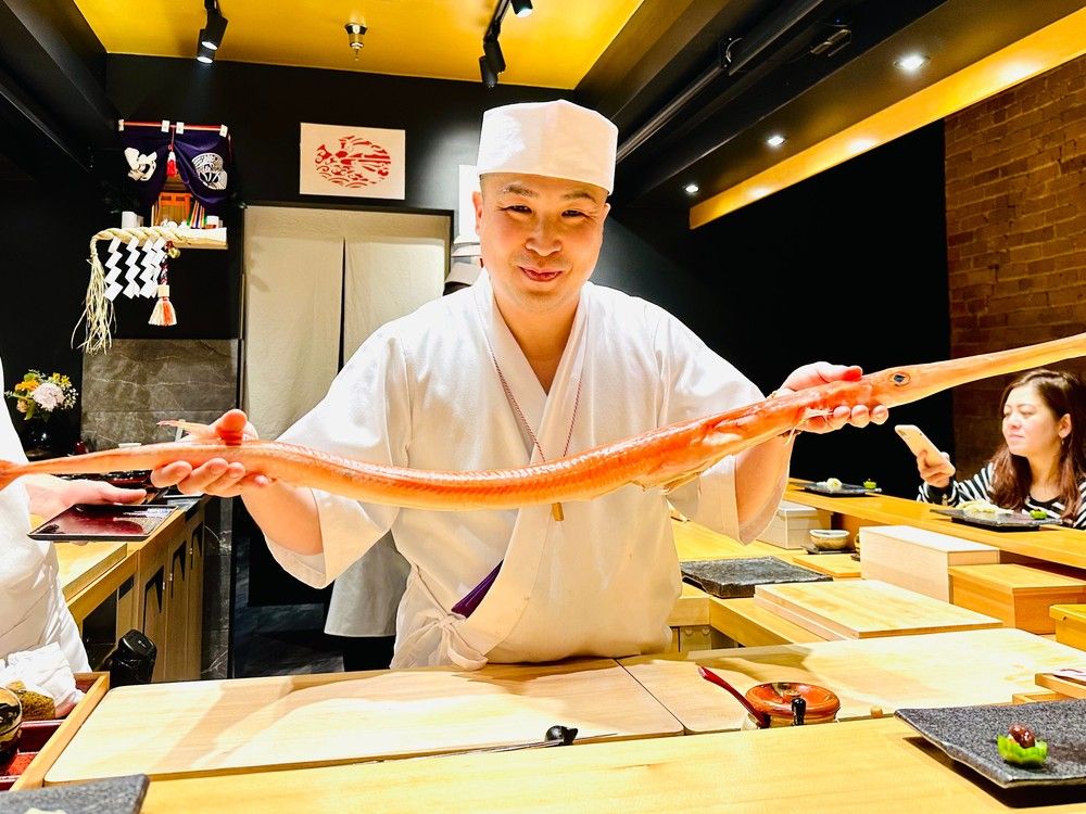 Okeya Kyujiro owner Takuya Matsuda with a trumpetfish.