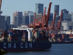 Statistics Canada says the country's merchandise trade balance shifted to a surplus in August helped by strong growth in exports of unwrought gold and crude oil. Gantry cranes sit idle as a container ship is docked at port during a work stoppage, in Vancouver, on Wednesday, July 19, 2023.