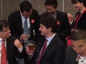 Prime Minister Justin Trudeau, front centre, attends a fundraiser with former Liberal MP Raymond Chan, left, and recently deceased Chinese businessman and Rongxiang (Tiger) Yuan, right.
