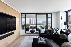 White-oak millwork was extended into the living room to provide more storage and encase the large TV to integrate it, rather than overpower the space.