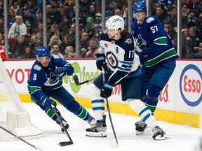 It was in this game against the Winnipeg Jets on Dec. 17, 2021, that J.T. Miller, left, helped inscribe Don't You (Forget About Me) into the Vancouver Canucks' canon.
