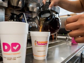 An employee fills a coffee order at a Dunkin' Donuts Inc. location in Ramsey, New Jersey, U.S.