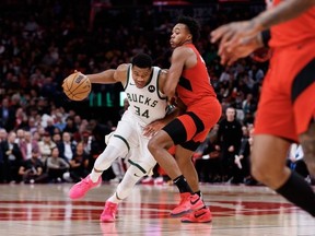 Giannis Antetokounmpo of the Milwaukee Bucks drives to the net against Scottie Barnes of the Toronto Raptors during the second half of their NBA game at Scotiabank Arena on November 1, 2023 in Toronto, Canada.