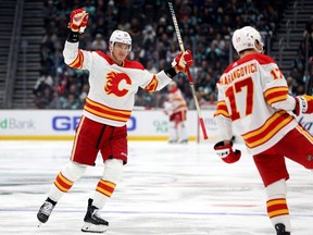 Nikita Zadorov #16 celebrates a goal by Yegor Sharangovich #17 of the Calgary Flames during the third period against the Seattle Kraken at Climate Pledge Arena on November 04, 2023 in Seattle, Washington.