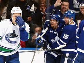 Nicholas Robertson #89 of the Toronto Maple Leafs (C) celebrates his third period goal against the Vancouver Canucks at Scotiabank Arena on November 11, 2023 in Toronto, Ontario, Canada.
