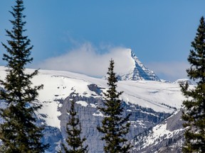 File photo: Clouds snag on Mount Assinboine, seen from Smith-Dorrien Trail in the still-wintery high country in Peter Lougheed and Spray Lakes Provincial Parks on Monday May 8, 2017.