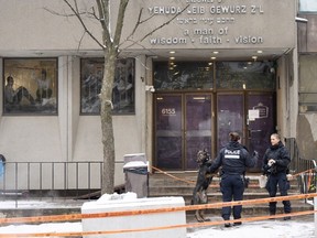 Police investigate the Yeshiva Gedolah school for clues after shots were fired at two Montreal Jewish schools on Nov. 9. Police say nobody was inside at the time of the shootings.