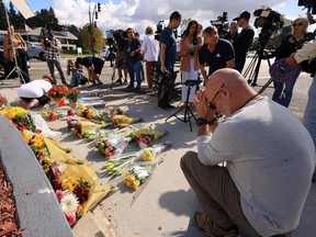 A man prays on Tuesday, Nov. 7, 2023, as flowers and candles are placed at the intersection where a protest the previous day led to the death of a Jewish man after an altercation with a pro-Palestinian man at a demonstration in Thousand Oaks, Calif.