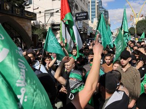 Palestinians shout slogans during a protest in the West Bank city of Hebron on Nov. 17.