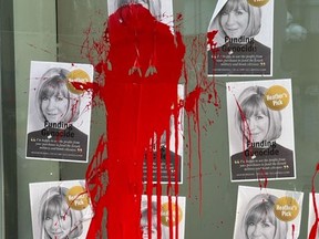 Red paint and posters on an Indigo bookstore in Toronto accusing CEO Heather Reisman of "funding genocide."