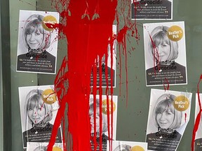 Posters of Indigo CEO Heather Reisman bearing the words "Funding Genocide” splattered with red paint outside an the company's bookstore near Bay and Bloor streets.