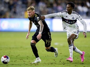 Los Angeles FC midfielder Mateusz Bogusz, left, and Vancouver Whitecaps forward Ali Ahmed vie for the ball during an MLS playoff game on Oct. 28 in L.A.