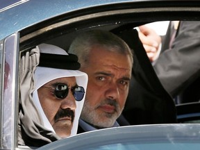 Senior Hamas leader Ismail Haniyeh, right, with Emir of Qatar Sheikh Hamad bin Khalifa al-Thani, arriving for the corner-stone laying ceremony of a new residential neighbourhood in the Gaza Strip in 2012.