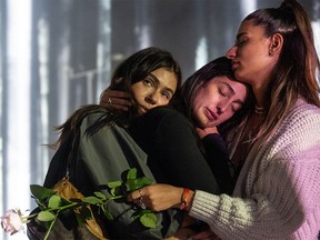 Survivors of the Nova music festival, at which at least 350 festival-goers were killed by Hamas terrorists in Israel on Oct. 7, embrace during a memorial evening on Nov. 11, 2023, in Caesarea.