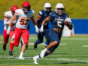 The T-Birds' Isaiah Knight runs the ball during a Men's U Sports game between the University of B.C. Thunderbirds and the University of Calgary Dinos at Thunderbird Stadium in Vancouver on Sept. 9.