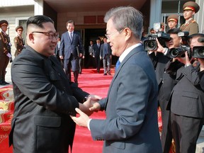 This photograph taken on May 26, 2018 and released by North Korea's official Korean Central News Agency (KCNA) on May 27 shows South Korea's President Moon Jae-in (R) shaking hands with North Korea's leader Kim Jong Un after their second summit at the north side of the truce village of Panmunjom in the Demilitarized Zone (DMZ). Kim Jong Un believed a summit with U.S. President Donald Trump was a landmark opportunity to end decades of confrontation, South Korea's President Moon Jae-in said May 27 following his surprise meeting with the North Korean leader.