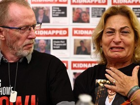 Orit Meir (R), mother of Almog Meir, cries next to Thomas Hand, father of Emily Hand, during a press conference by families of hostages held by Hamas in Gaza, at the embassy of Israel in London on November 20, 2023.