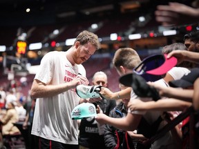 Toronto Raptors' Jakob Poeltl signs autographs before a preseason NBA basketball game against the Sacramento Kings, in Vancouver on Oct. 8, 2023.