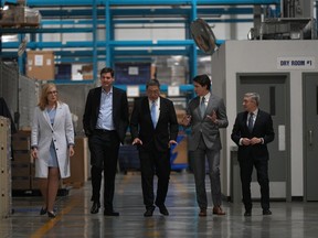 B.C. Minister of Jobs, Economic Development and Innovation Brenda Bailey, from left to right, B.C. Premier David Eby, Nelson Chang, Chairman of TCC Group, E-One Moli Energy (Canada), Prime Minister Justin Trudeau and Minister of Innovation, Science and Industry Francois-Philippe Champagne tour the lithium battery manufacturer E-One Moli Energy (Canada), in Maple Ridge, B.C., on Tuesday, November 14, 2023.
