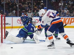 Vancouver Canucks goalie Thatcher Demko (35) watches as New York Islanders' Bo Horvat (14) puts a shot wide of the goal during the second period on Wednesday night at Rogers Arena.