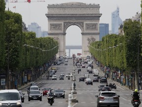 FILE - Cars drive on the Champs Elysee avenue, Thursday, May 7, 2020 in Paris. Paris mayor says her city has too many SUVs, so she's asking voters to decide on parking fee hike on Feb. 4, 2024. The Arc de Triomphe is seen in background.
