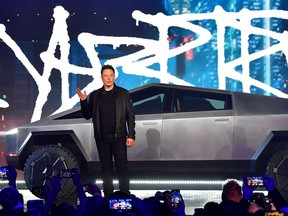 Elon Musk introduces the newly unveiled all-electric battery-powered Tesla Cybertruck at Tesla Design Center in Hawthorne, Calif., on Nov. 21, 2019.