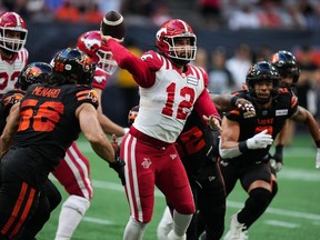 Calgary Stampeders quarterback Jake Maier passes while under pressure from the B.C. Lions' defence during a CFL game in Vancouver on Aug. 12. The Stamps pulled off a huge road win over the Leos two weeks ago to save their season.