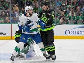 Vancouver Canucks left-winger Phillip Di Giuseppe and Dallas Stars defenceman Colin Miller battle for position in the Stars' crease at the American Airlines Center on March 25.