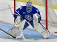 Dalyn Wakely of the North Bay Battalion roofs the puck past Mississauga Steelheads goalie Roman Basran in a 3-2 OHL victory via shootout.