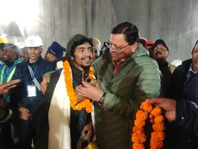 Chief Minister of the state of Uttarakhand, greeting a worker rescued from the site of an under-construction road tunnel that collapsed in Silkyara in the northern Indian state of Uttarakhand, India,.