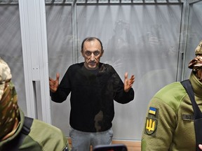Col. Roman Chervinsky appears in a glass room during a hearing in the Shevchenko District Court in Kyiv, Ukraine, on Oct. 10, 2023.