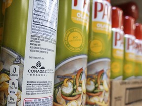 FILE - Cooking spray oils by Pam, a Conagra brand, rest on a supermarket shelf, June 25, 2019, in Cincinnati. On Monday, Oct. 30, 2023, a jury in Illinois ordered Chicago-based Conagra Brands to pay $7.1 million to a Pennsylvania woman who was badly injured in 2017 when a can of commercial brand cooking spray ignited in a kitchen at her workplace and set her aflame. The verdict is the first of numerous other cases from burn victims across the country with similar stories citing accidents that occurred with Conagra-made cooking spray brands, including its popular grocery store brand Pam.