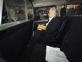 Seen through a police vehicle window, Peter Nygard arrives to a Courthouse in Toronto, Tuesday, Oct. 3, 2023, to attend his trial, accused of five counts of sexual assault and one count of forcible confinement in alleged incidents ranging from the 1980s to mid-2000s.