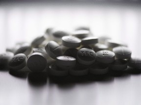 Prescription pills containing oxycodone and acetaminophen are shown in this June 20, 2012 photo. The British Columbia government goes up against dozens of health care and pharmaceutical companies in court today in a bid get certification for a class-action lawsuit over the costs of the opioid crisis.