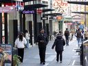People go about their business on Granville Street in Vancouver on Nov. 7. Many business owners are experiencing more theft and crime, and are worried about their employees.