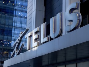 Telus Corp. is reporting a 75 per cent year-over-year drop in profits in its latest quarter, despite a solid revenue boost and record telecom customer growth. A Telus sign is shown in Toronto on Thursday, Feb. 11, 2021.