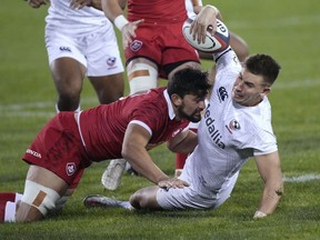 Canada's Lucas Rumball, left, tackles U.S. wing Christian Dyer during the first half of a Rugby World Cup 2023 qualification pathway match Saturday, Sept. 11, 2021, in Glendale, Colo. Rumball scored three tries Saturday as Canada defeated Brazil 40-15 to finish third at the four-team La Vila International Rugby Cup.